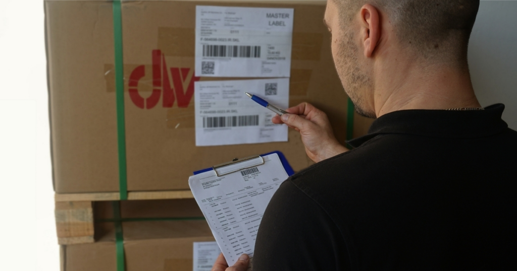 Warehouse staff inspecting incoming parcels before export shipping