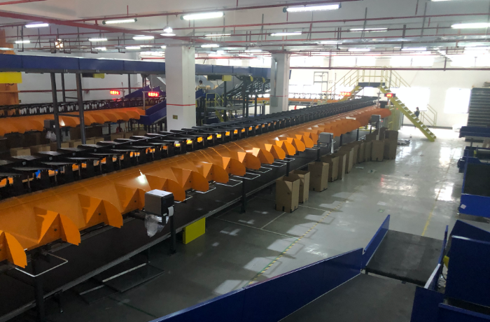 Parcels moving through warehouse sortation before international shipping from China