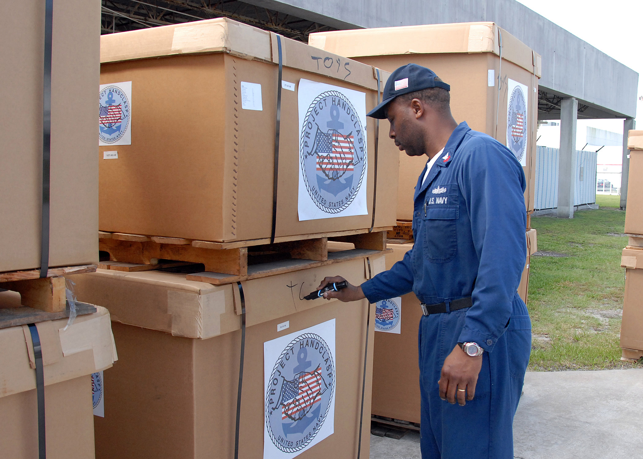 Worker labeling a warehouse carton before storage