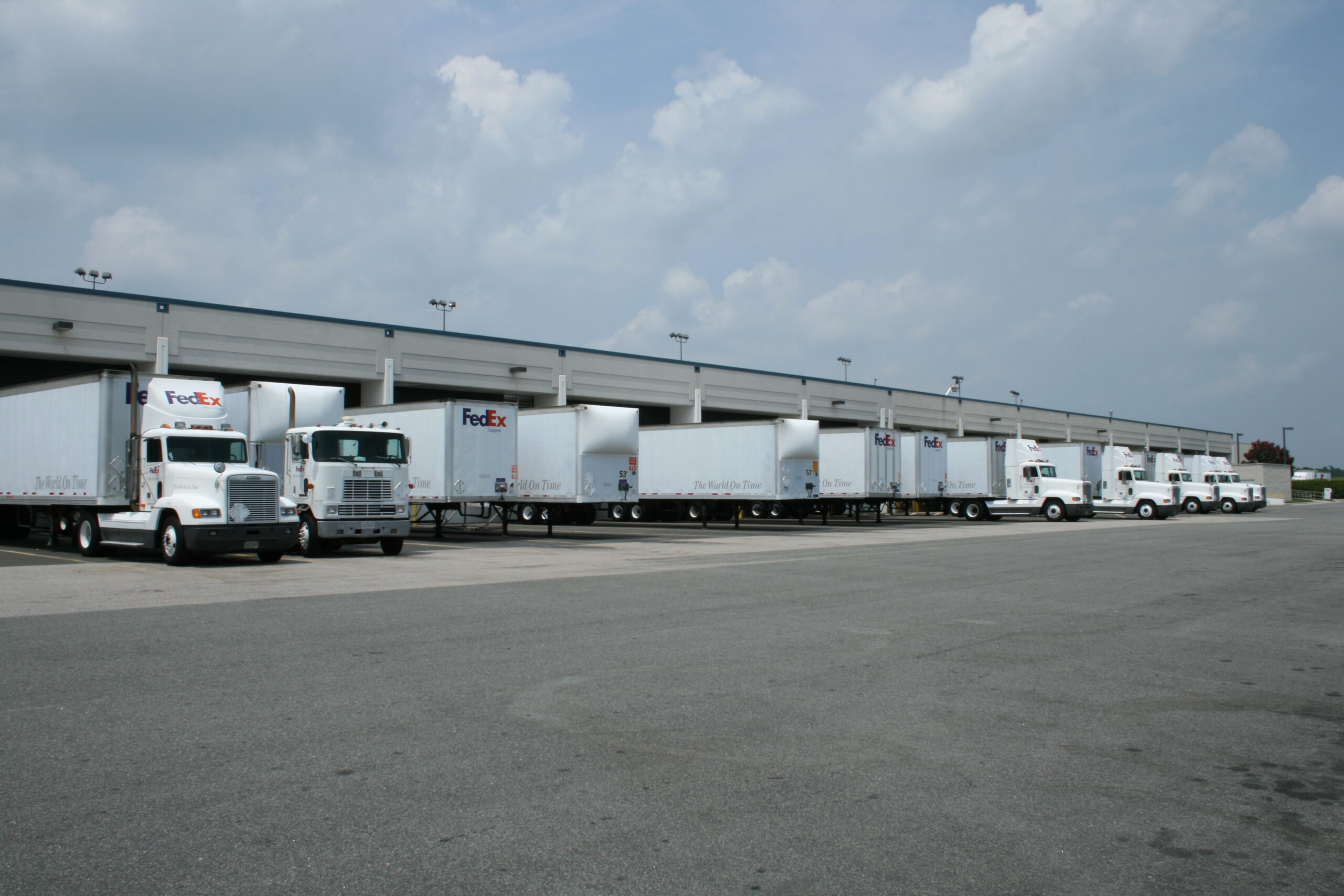 Courier trucks docked at an air cargo facility