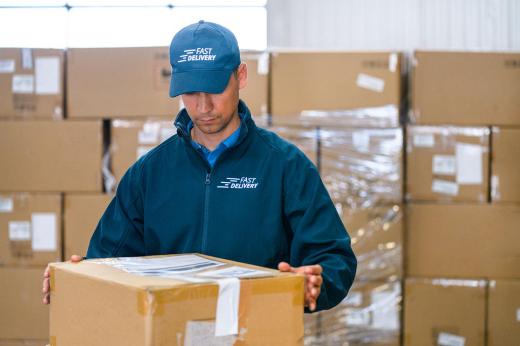 Courier inspecting a package before international shipping from China