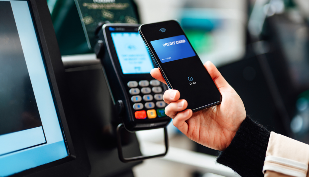Mobile wallet payment setup showing smartphone and card terminal during checkout