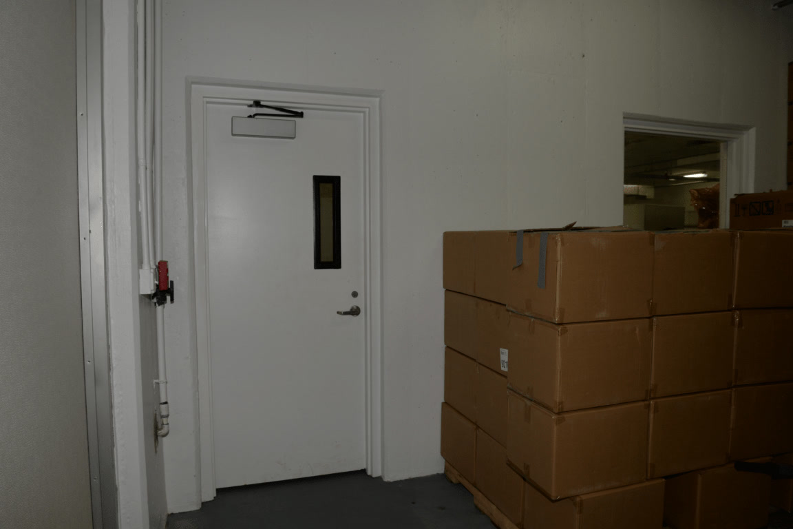 Cardboard boxes stacked on a pallet inside a warehouse
