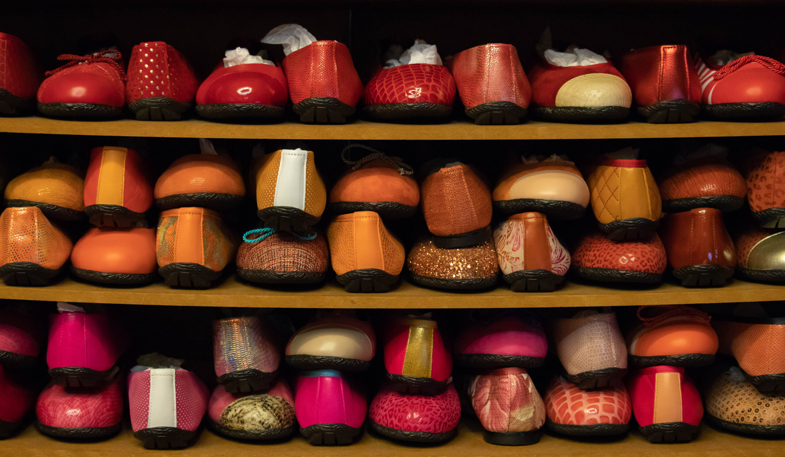 Shoe store shelves with many pairs of shoes