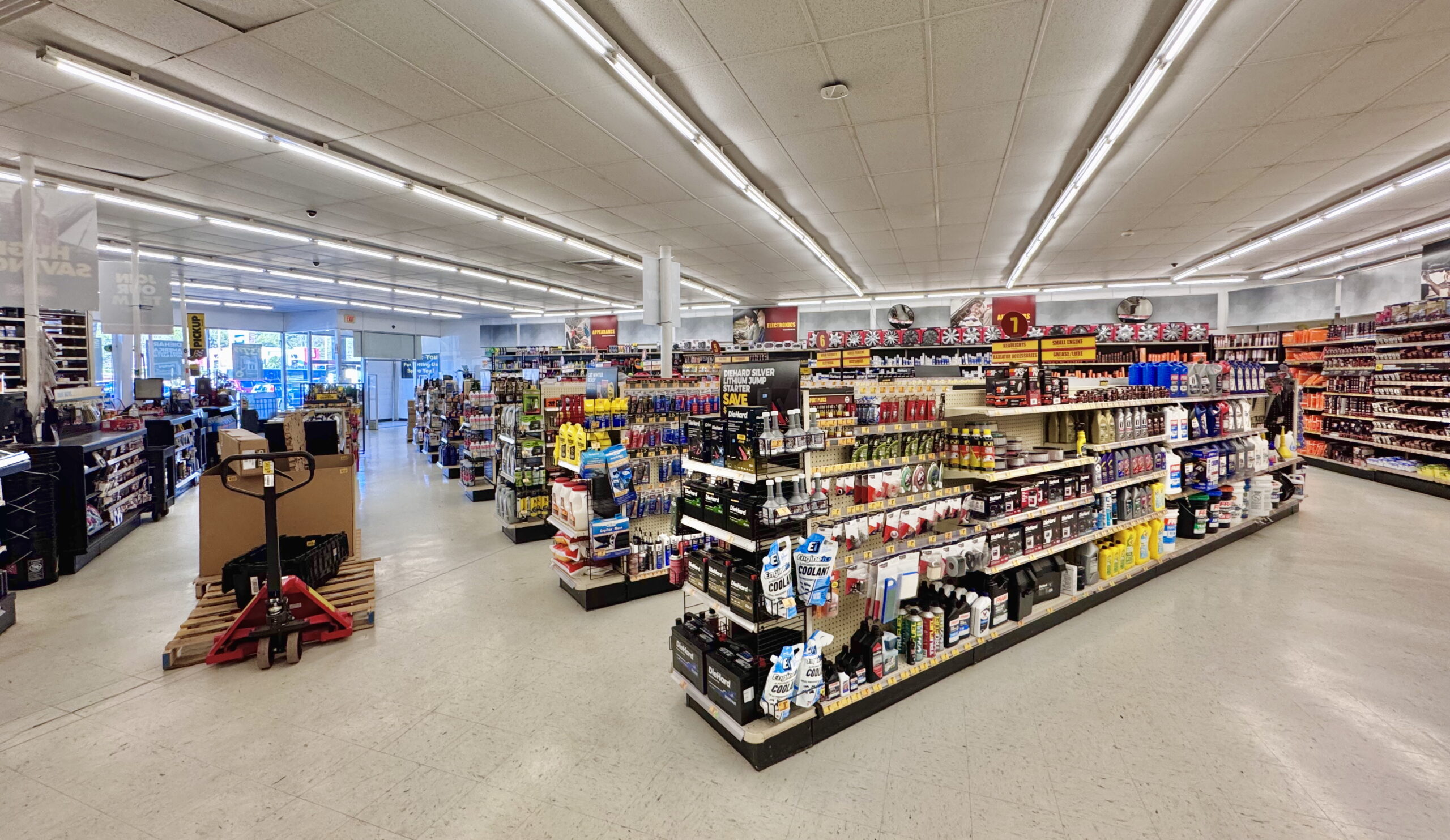 Auto parts store aisle with boxed vehicle accessories and parts