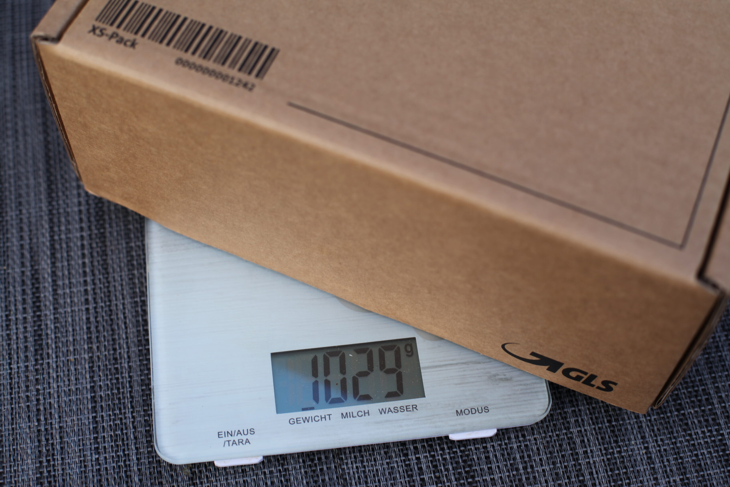 Small parcel being weighed on a scale before shipping