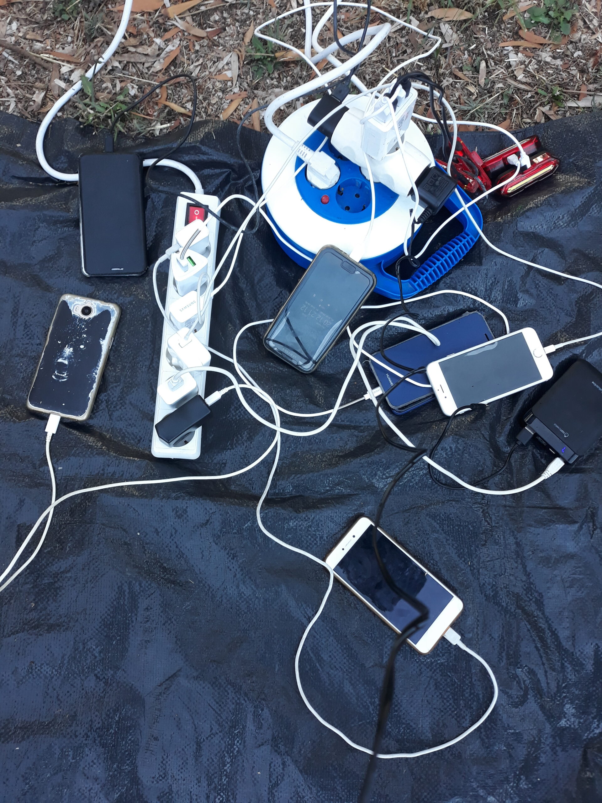 Smartphones on a table being charged