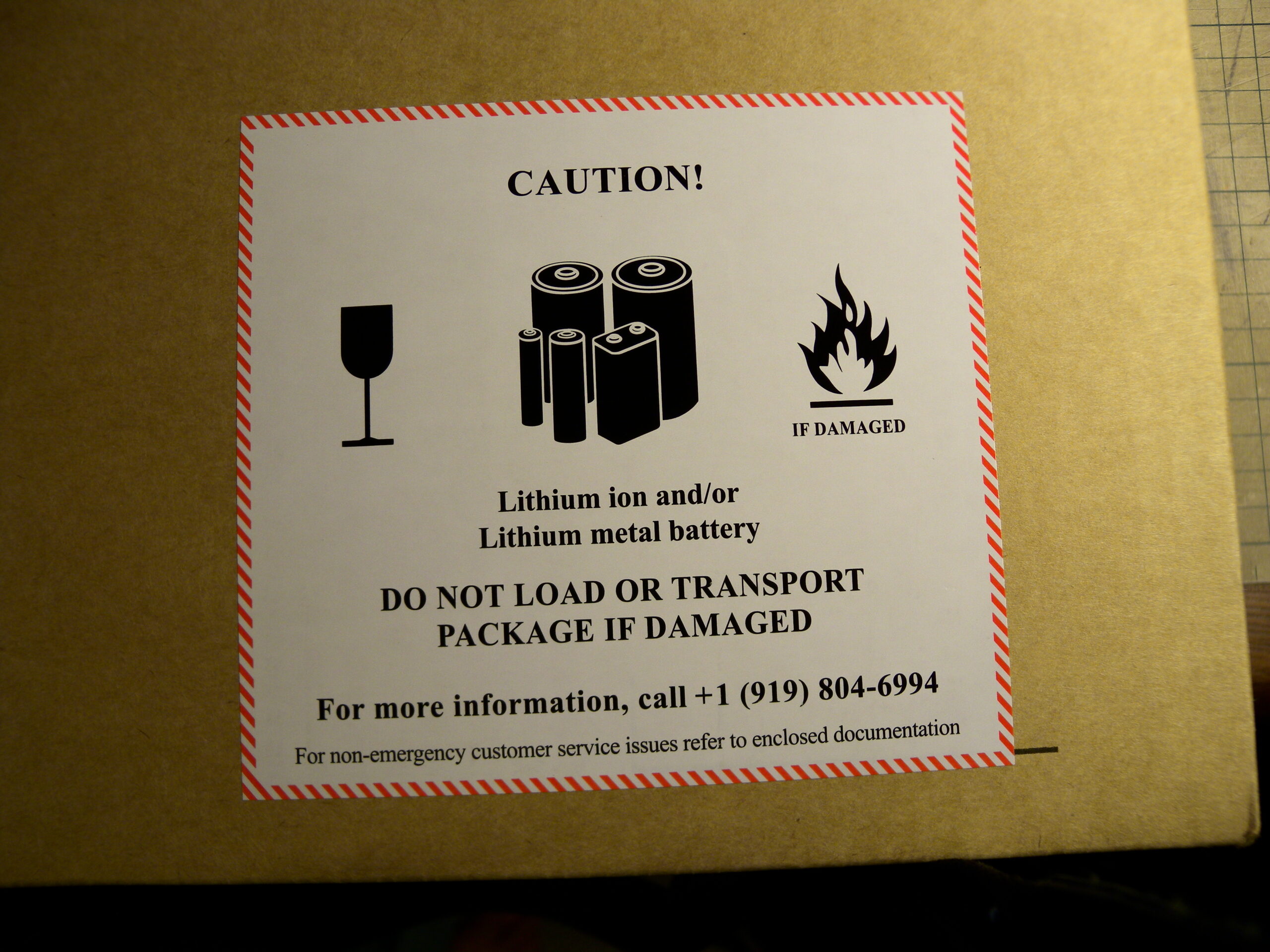 Warning label on a damaged lithium battery package