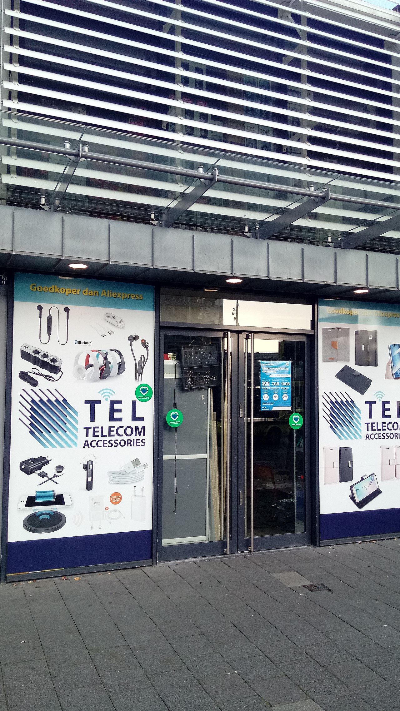Second telecom accessories storefront showing a different real-world mobile accessory retail angle