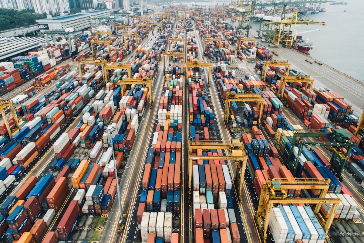 Container ship at port with cranes loading shipping containers