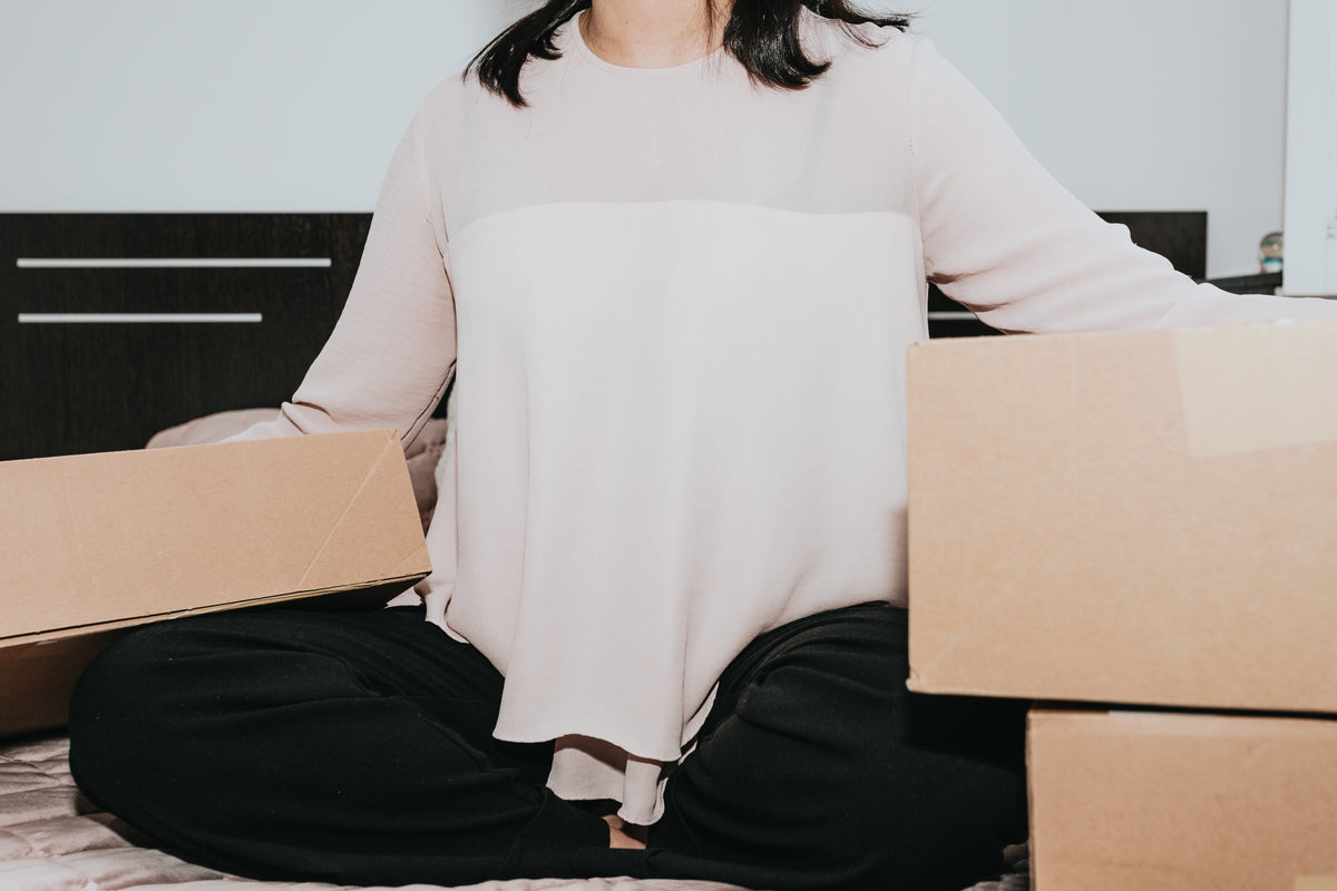 Person receiving clothing delivery package from online order