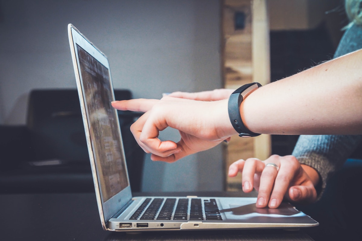 Person researching shipping consolidation questions on laptop