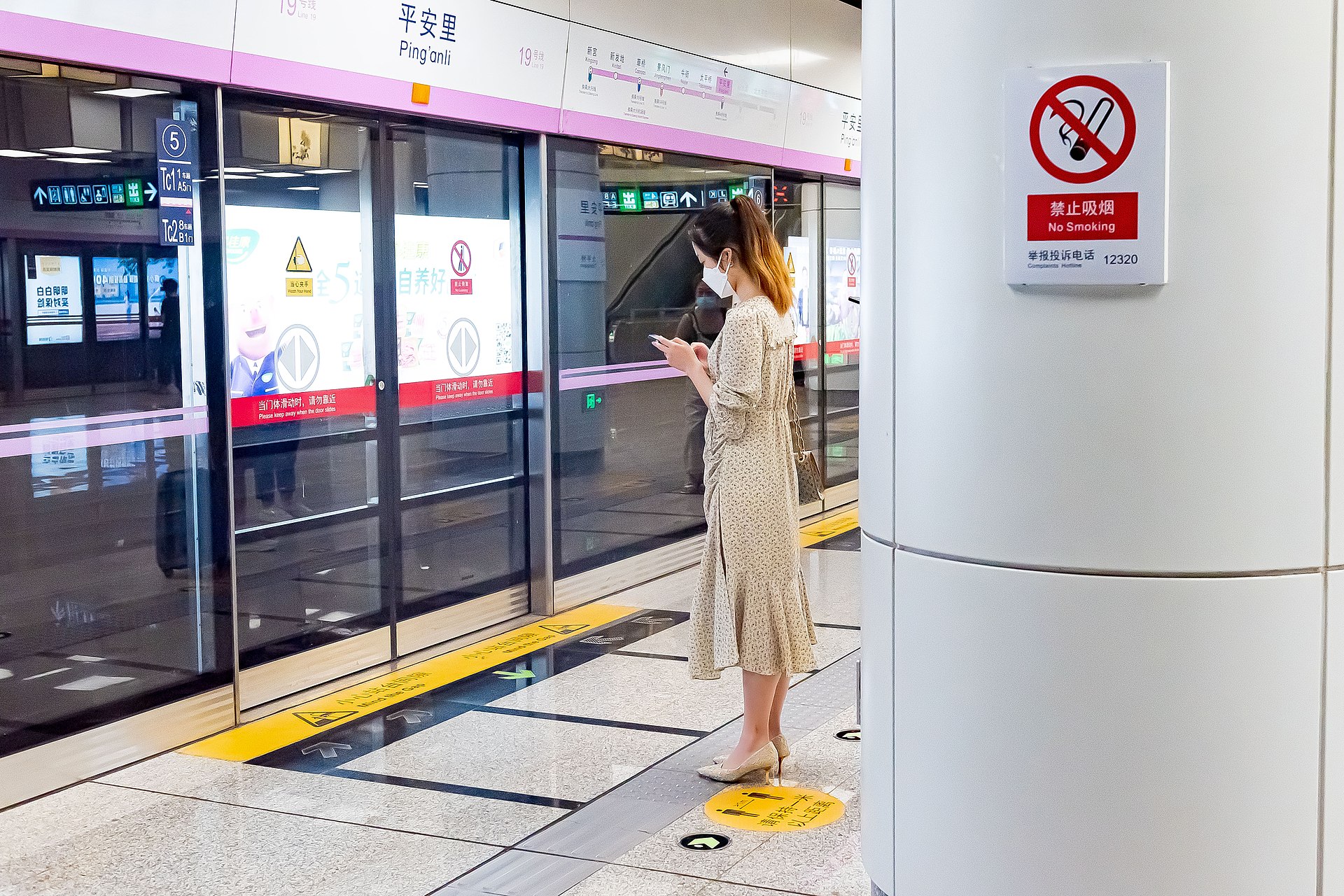Person using a smartphone in Beijing, representing mobile-first Chinese marketplace workflows like Xianyu