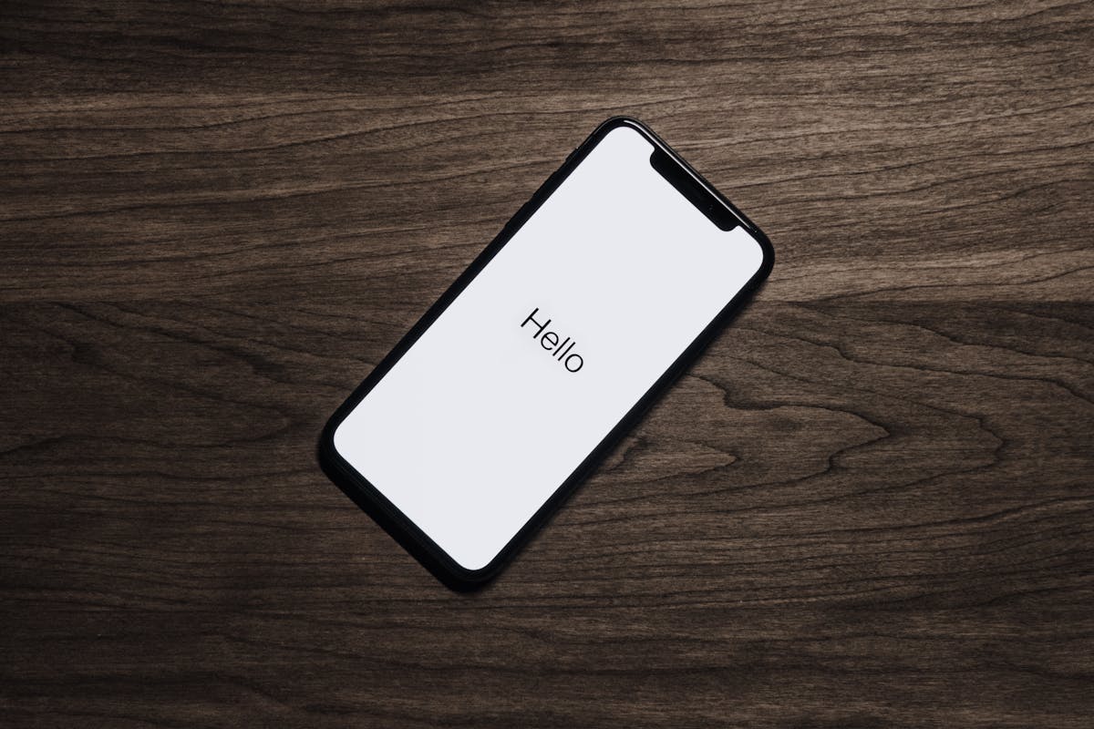 Smartphone being unboxed on a desk, showing the inspection step at the warehouse