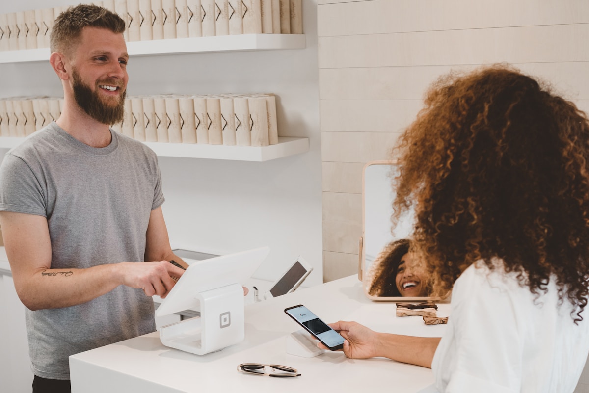 Person troubleshooting mobile payment on phone with card nearby